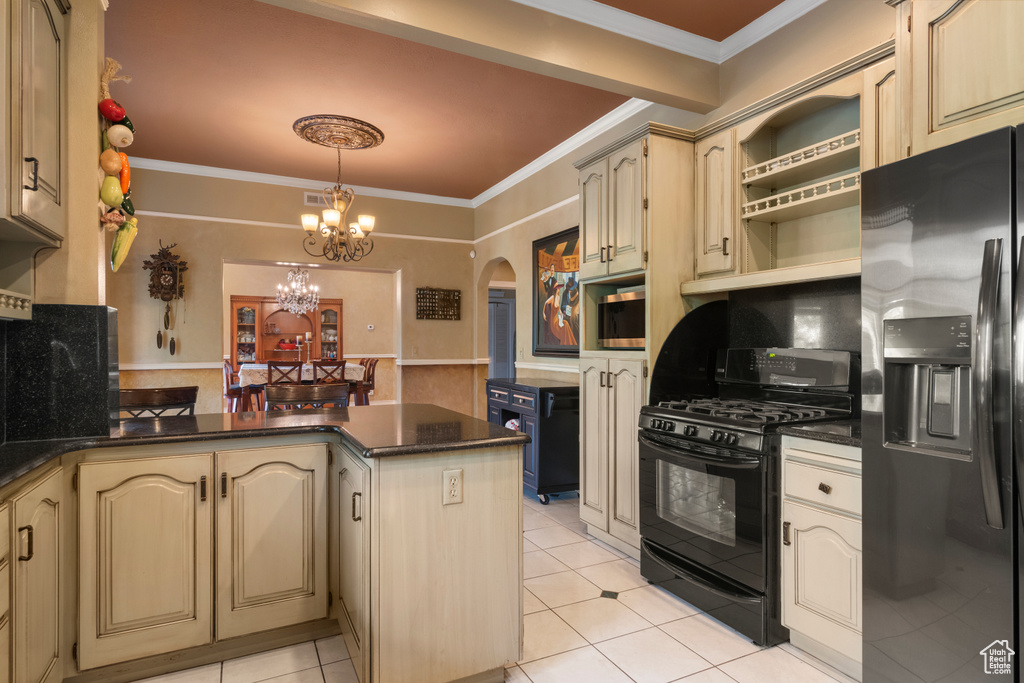 Kitchen with a peninsula, appliances with stainless steel finishes, arched walkways, and ornamental molding