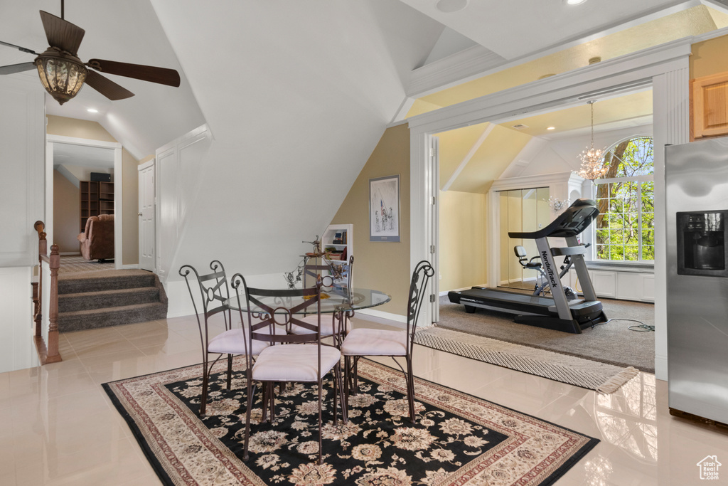 Dining area with ceiling fan with notable chandelier, vaulted ceiling, and recessed lighting