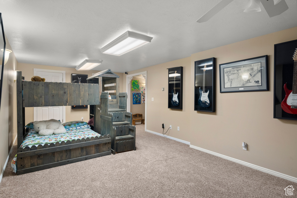 Bedroom featuring baseboards, carpet, and ceiling fan