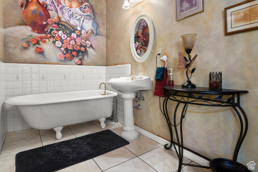 Bathroom featuring a freestanding tub and baseboards