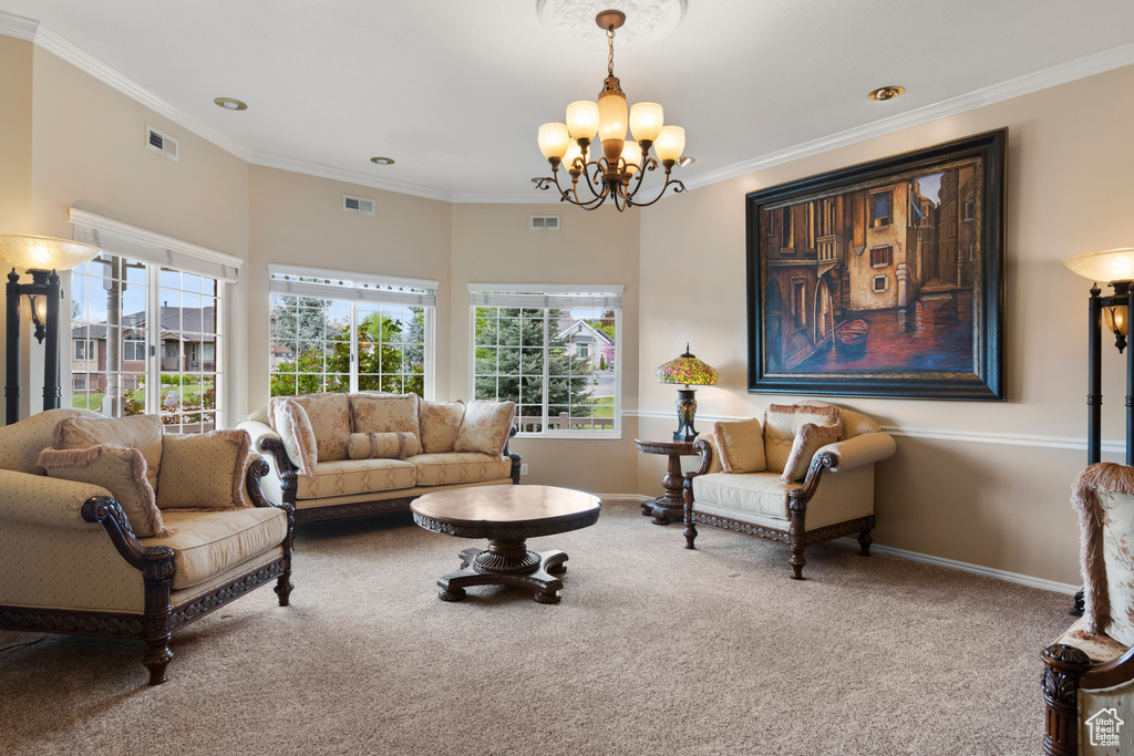 Living area with a wealth of natural light, carpet, a chandelier, and visible vents