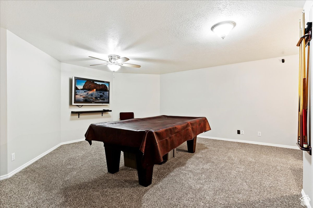 Playroom with billiards, ceiling fan, a textured ceiling, baseboards, and carpet