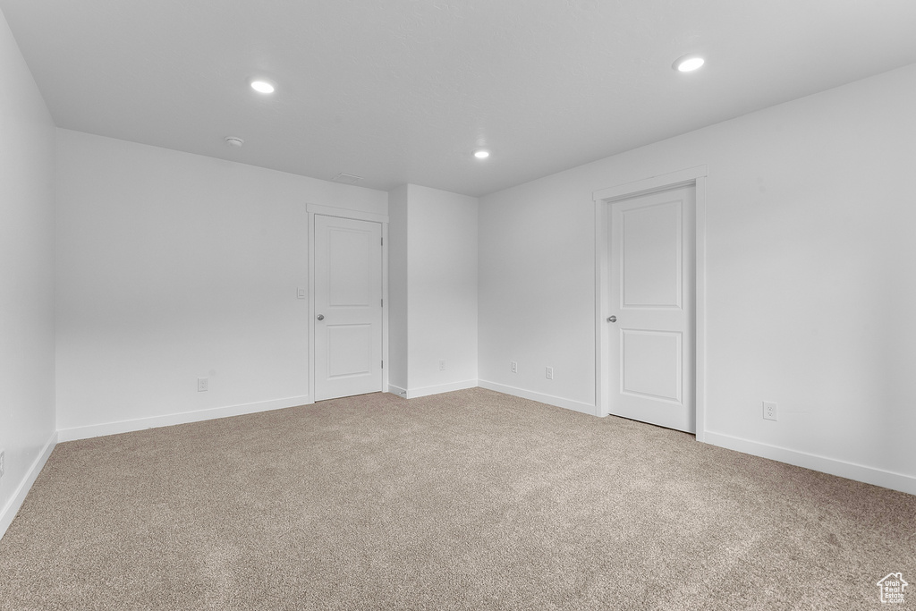 Spare room featuring baseboards, carpet flooring, and recessed lighting