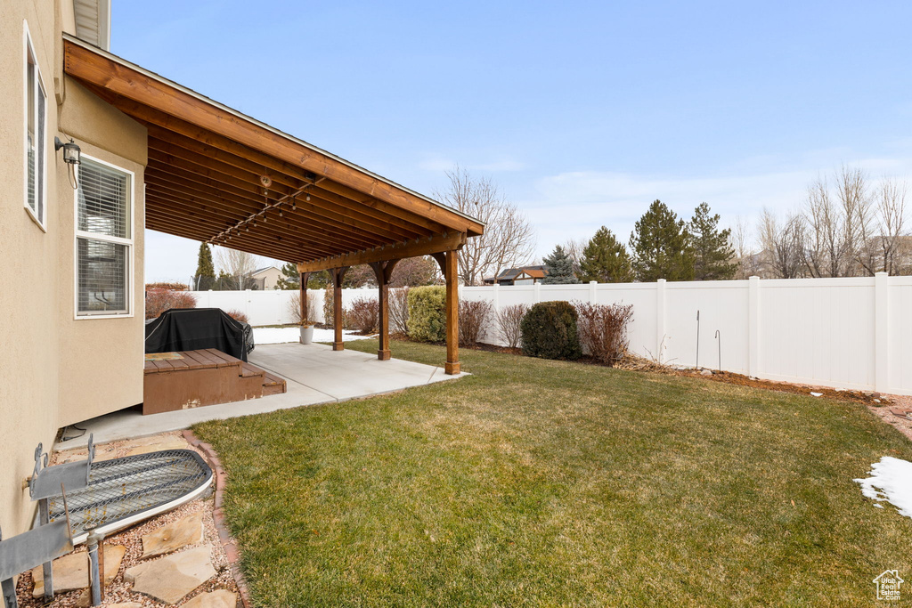 View of yard featuring a fenced backyard and a patio area