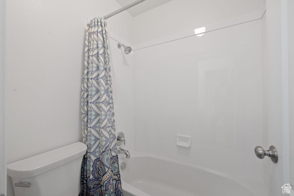 Bathroom with shower / bath combo and toilet