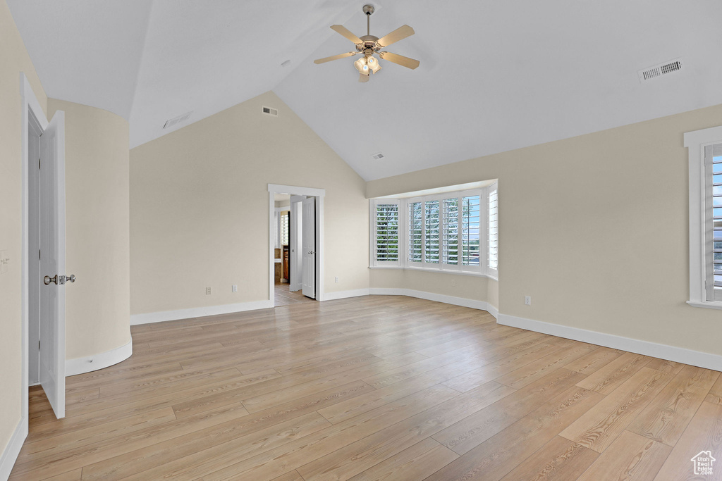 Unfurnished living room featuring ceiling fan, visible vents, and light wood-style flooring