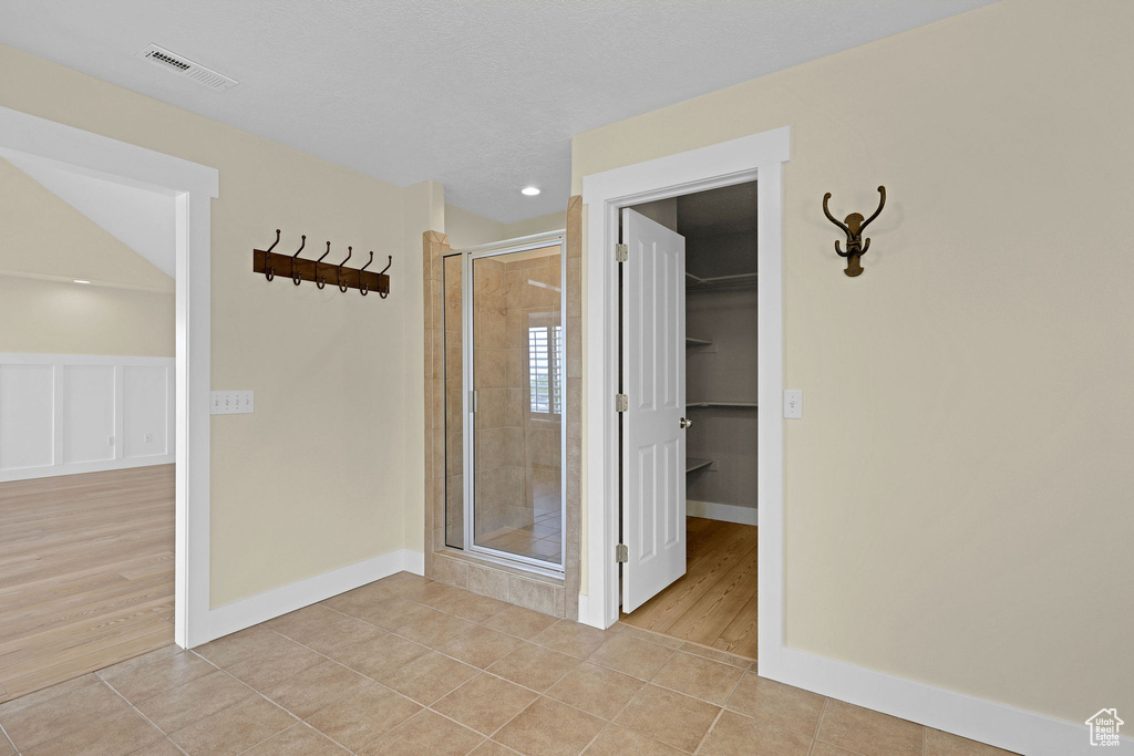 Full bathroom featuring visible vents, tile patterned floors, and a stall shower