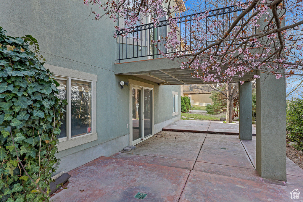 View of patio featuring a balcony