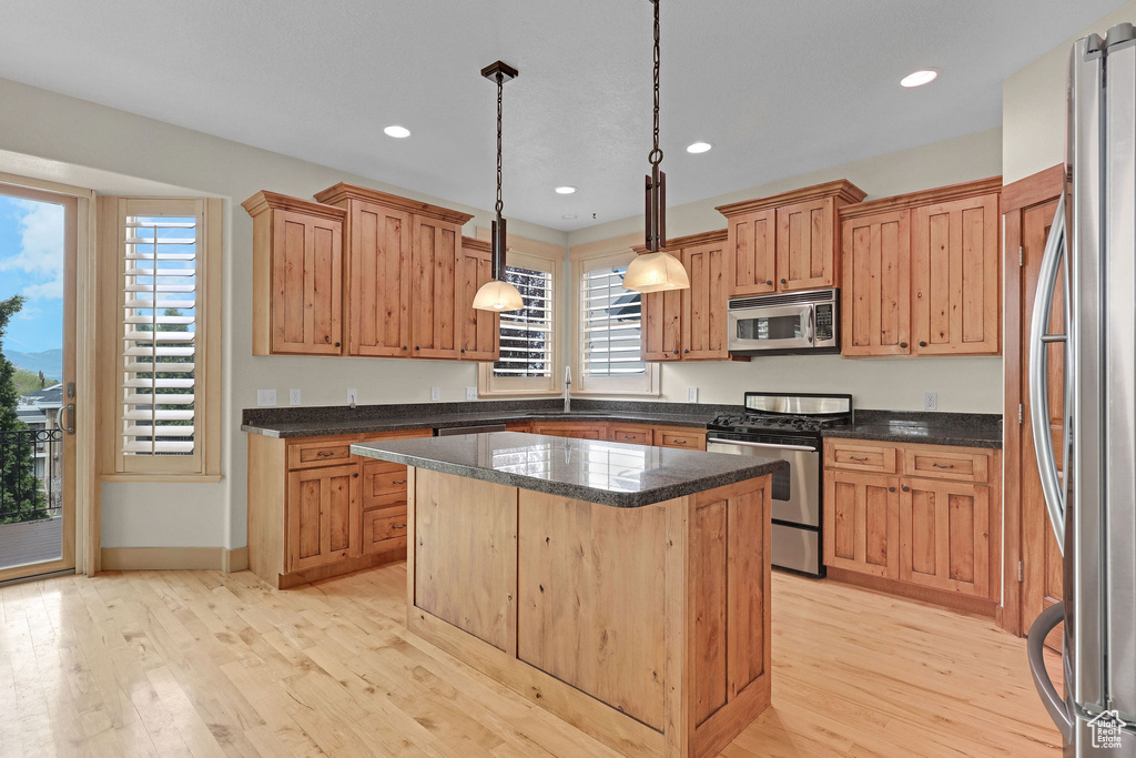 Kitchen featuring recessed lighting, light wood-style flooring, a center island, and stainless steel appliances
