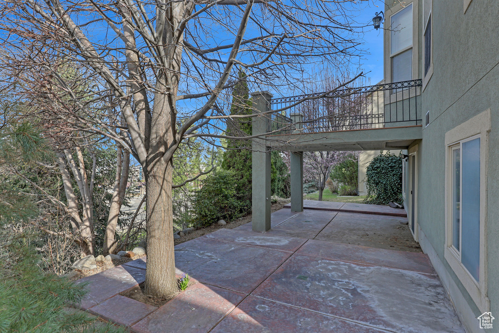 View of patio with a balcony