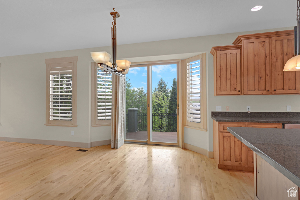 Unfurnished dining area with visible vents, baseboards, recessed lighting, light wood-type flooring, and a chandelier