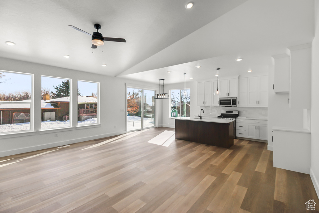 Kitchen with light countertops, recessed lighting, ceiling fan, and appliances with stainless steel finishes