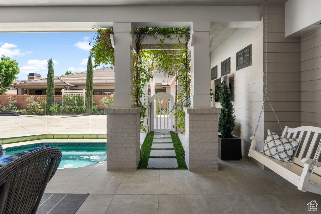 View of swimming pool featuring fence, a gate, and a swimming pool