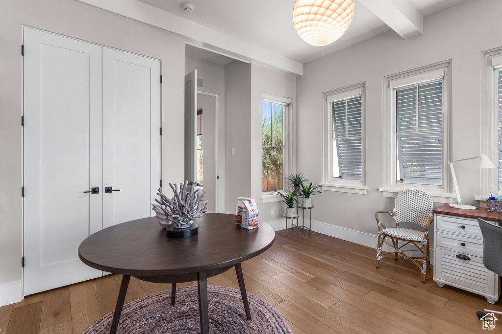 Home office with beamed ceiling, baseboards, and light wood finished floors