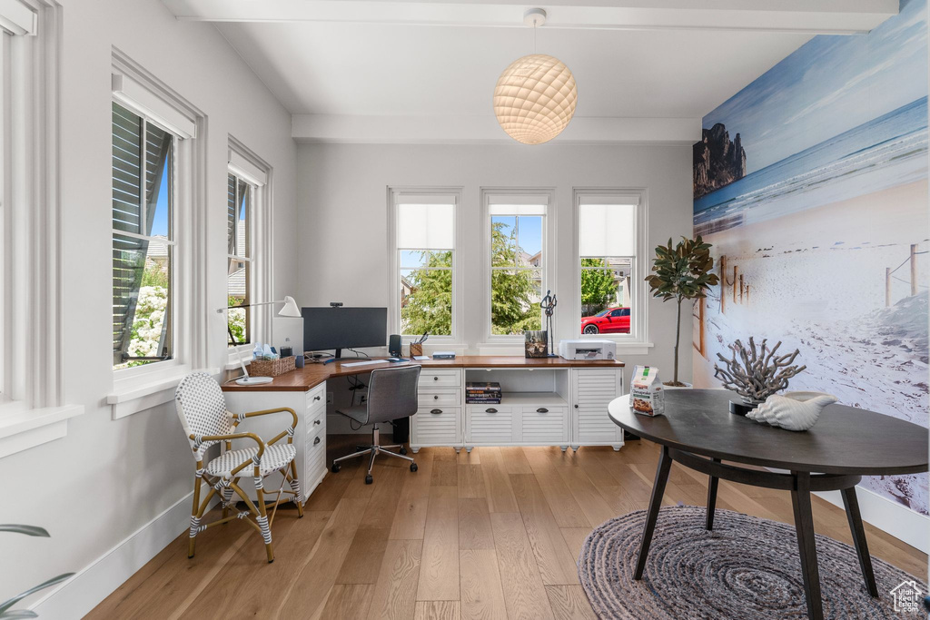 Office featuring baseboards, plenty of natural light, light wood-style flooring, and built in study area