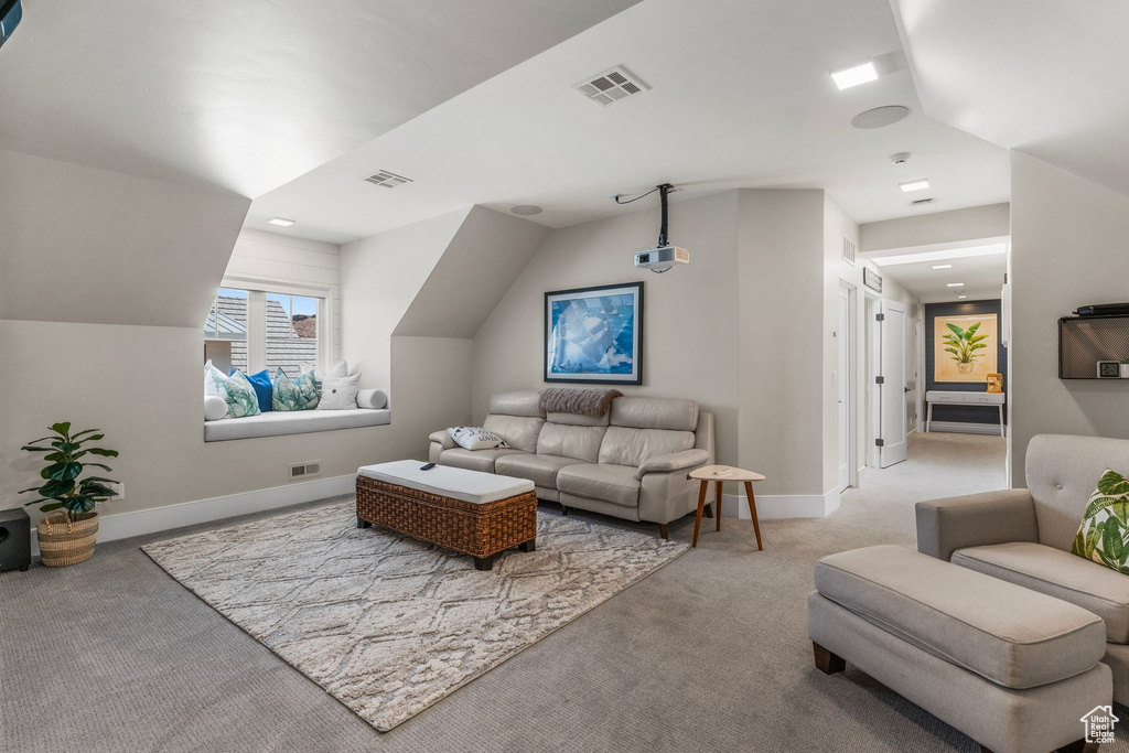 Carpeted living area featuring baseboards and visible vents