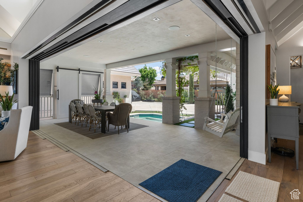 Interior space featuring light wood finished floors and a barn door