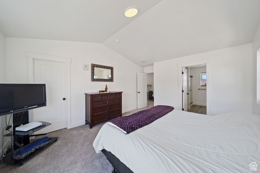 Bedroom featuring baseboards, carpet flooring, and lofted ceiling