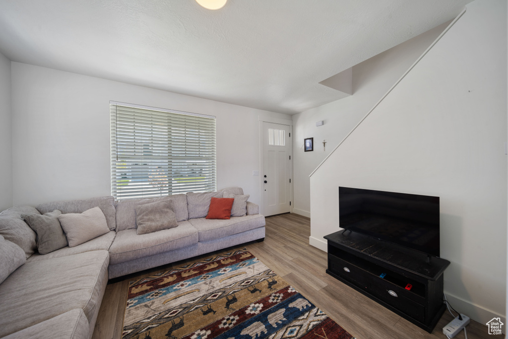 Living area featuring baseboards and wood finished floors