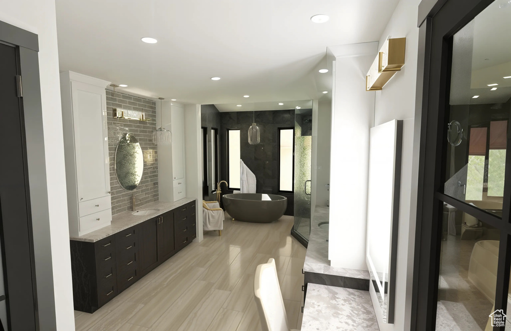 Full bath featuring recessed lighting, a soaking tub, and vanity