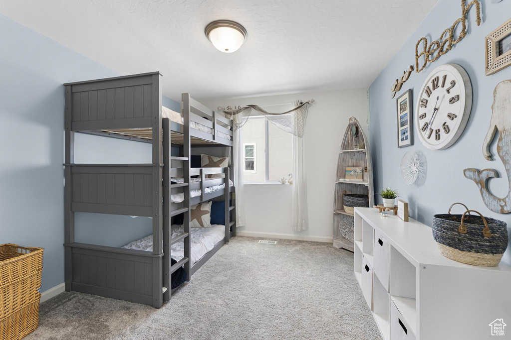 Carpeted bedroom with baseboards