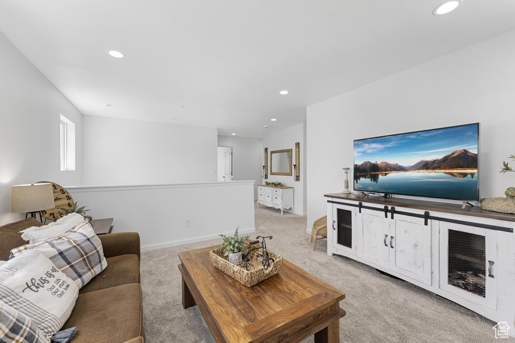 Living room with recessed lighting and light carpet