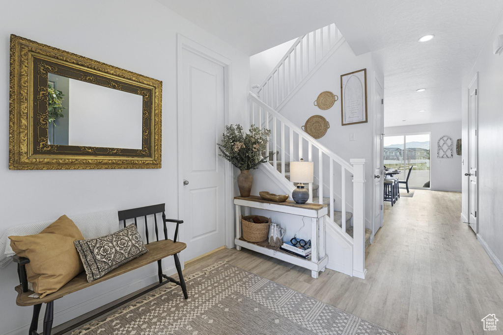 Stairs featuring recessed lighting and wood finished floors