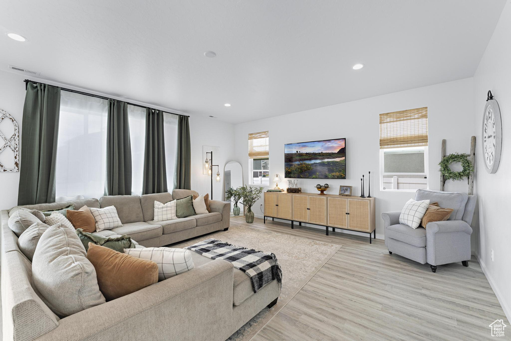 Living area featuring recessed lighting, light wood finished floors, baseboards, and visible vents