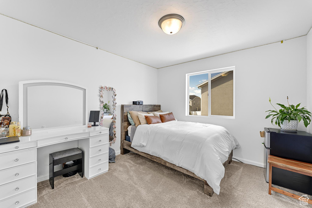 Bedroom with light colored carpet