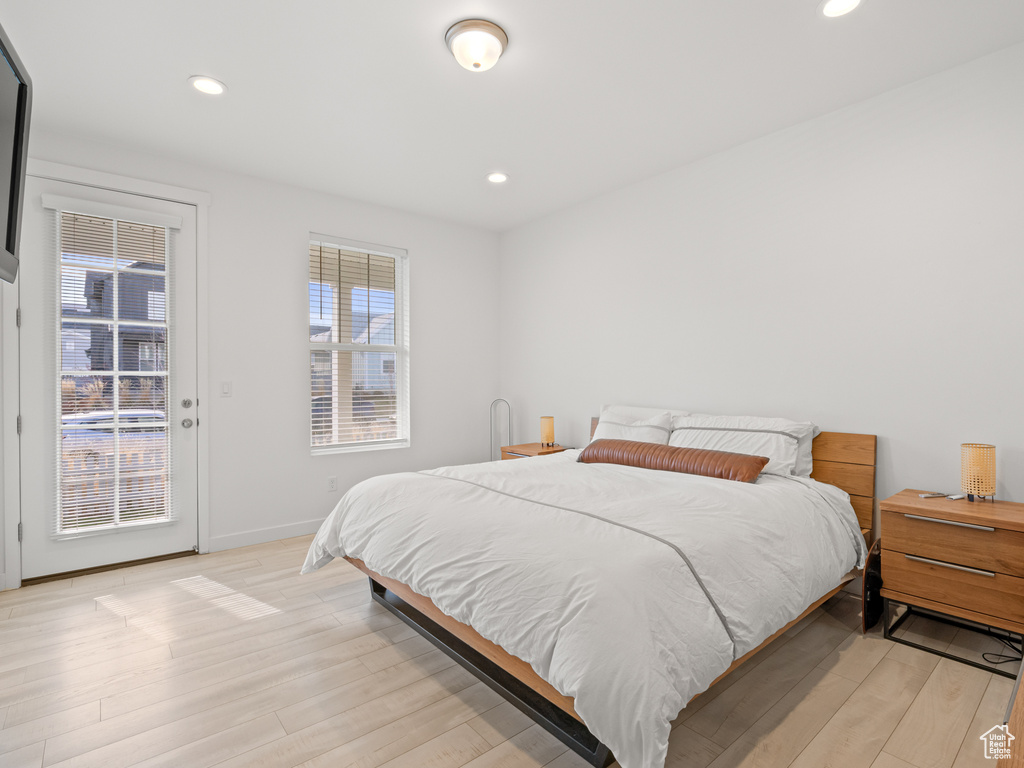 Bedroom with access to outside, light wood-type flooring, baseboards, and recessed lighting