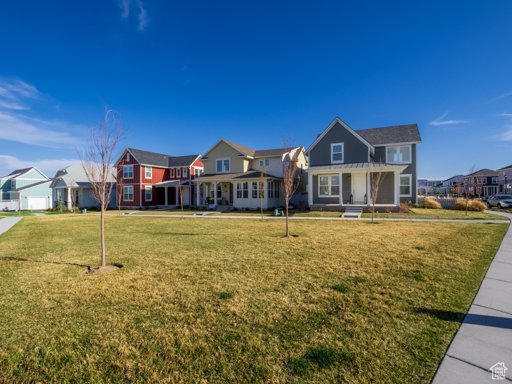 View of front of property featuring a front lawn and a residential view
