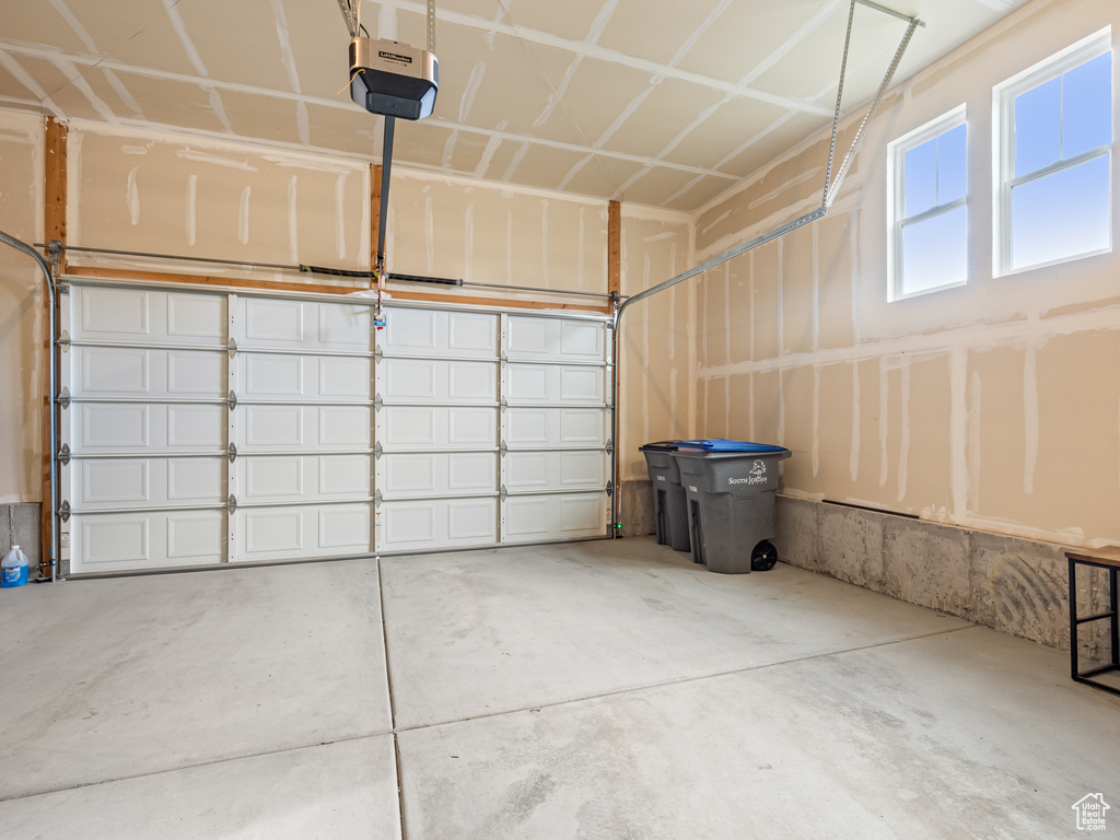 Garage featuring a garage door opener