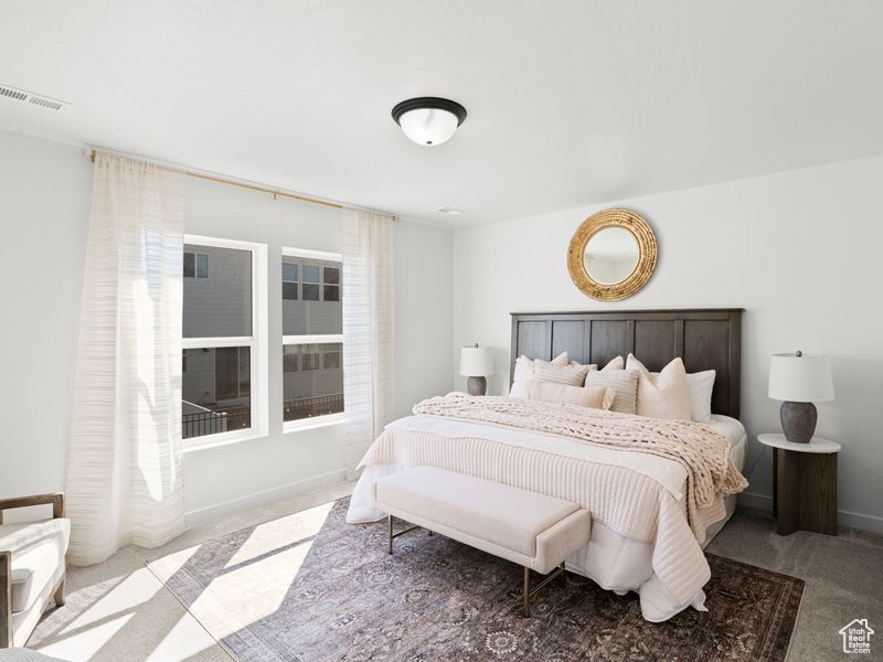 Bedroom with visible vents and carpet