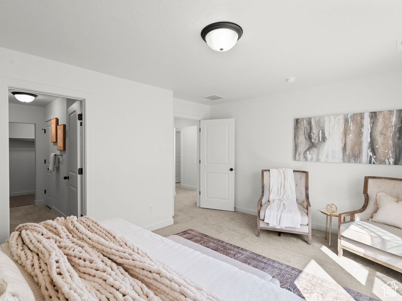 Bedroom featuring baseboards, carpet flooring, and visible vents
