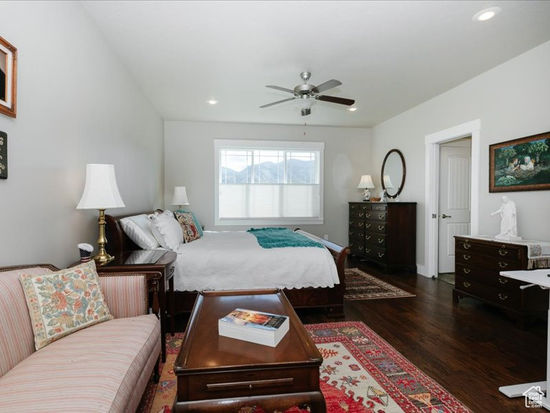 Bedroom with recessed lighting, a ceiling fan, dark wood-style flooring, and baseboards