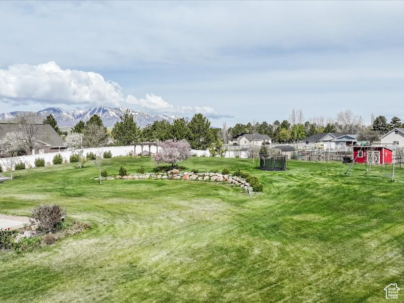 View of yard featuring fence and a mountain view