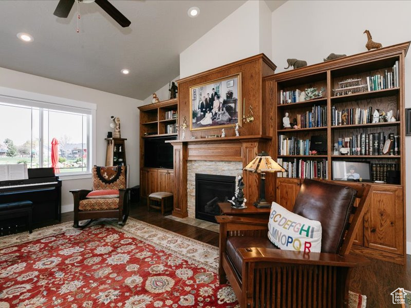Sitting room featuring a fireplace with flush hearth, wood finished floors, recessed lighting, a ceiling fan, and vaulted ceiling
