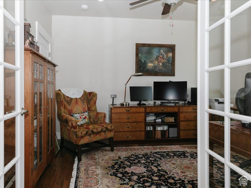 Office space with ceiling fan, french doors, and wood finished floors