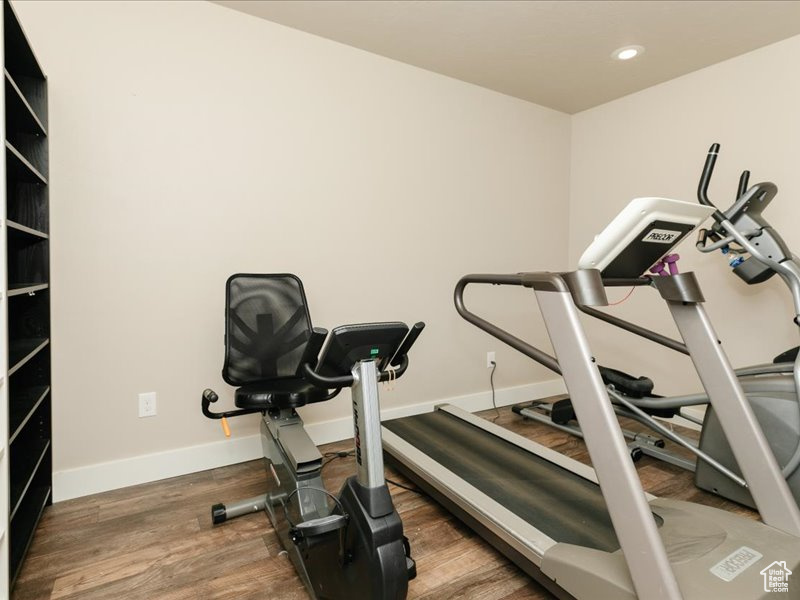 Workout room with recessed lighting, baseboards, and wood finished floors