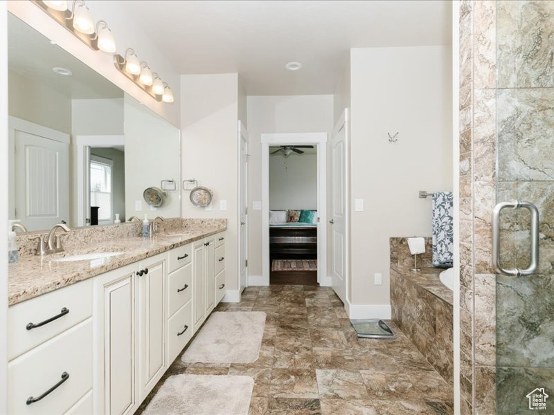 Ensuite bathroom with an enclosed shower, double vanity, a sink, and a garden tub