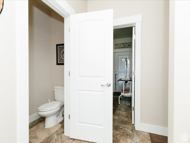 Bathroom featuring baseboards and toilet