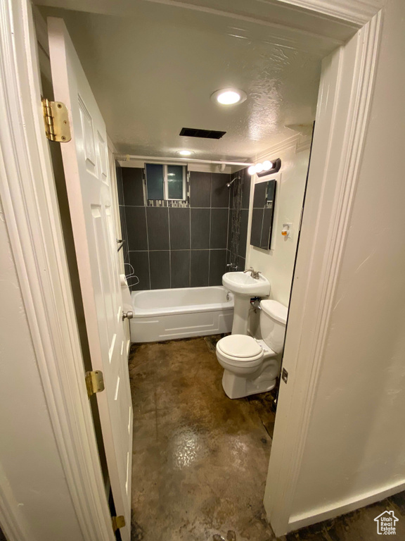 Full bathroom with toilet, recessed lighting, concrete floors, and shower / bathing tub combination