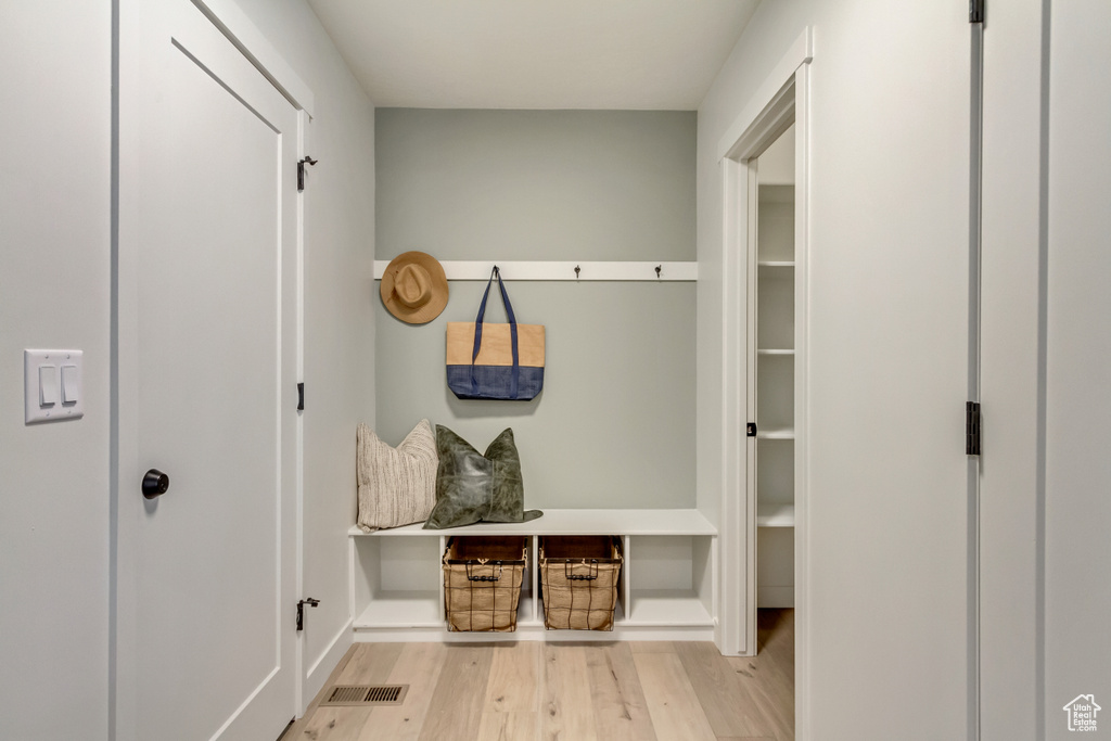 Mudroom featuring visible vents and wood finished floors