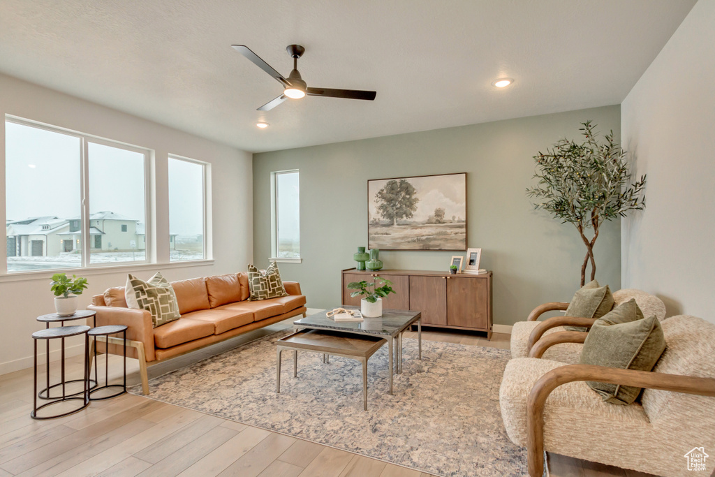 Living room with baseboards, recessed lighting, light wood-style floors, and a ceiling fan