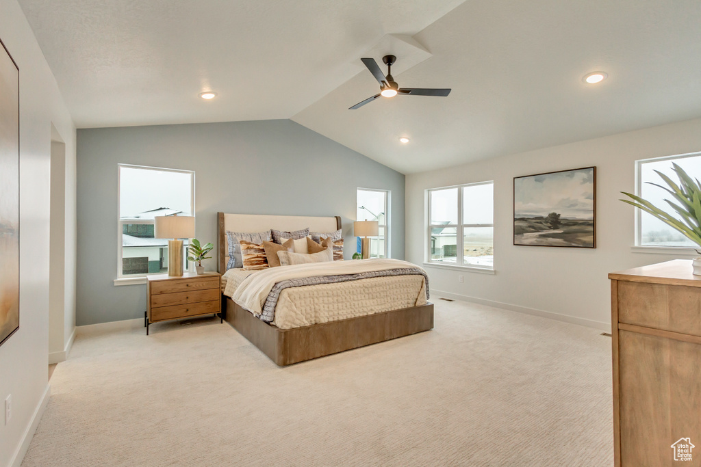 Bedroom with vaulted ceiling, a ceiling fan, baseboards, light colored carpet, and recessed lighting