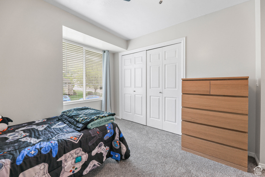Carpeted bedroom with a closet