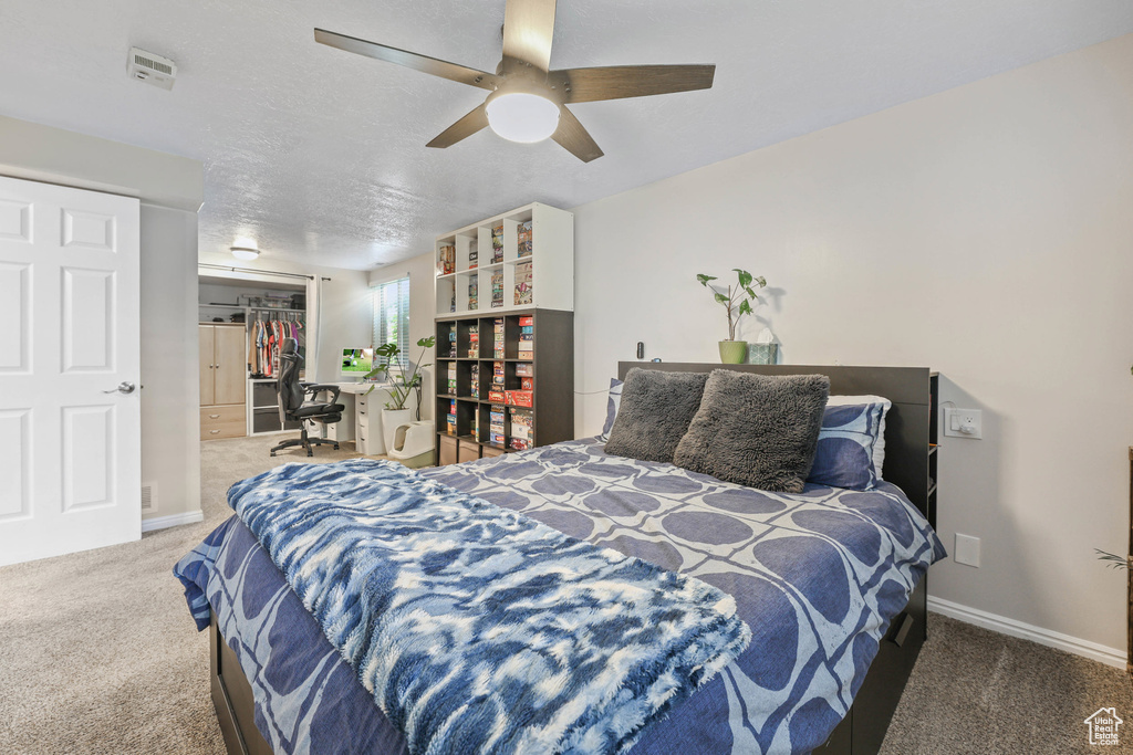 Bedroom with carpet floors, baseboards, and a closet