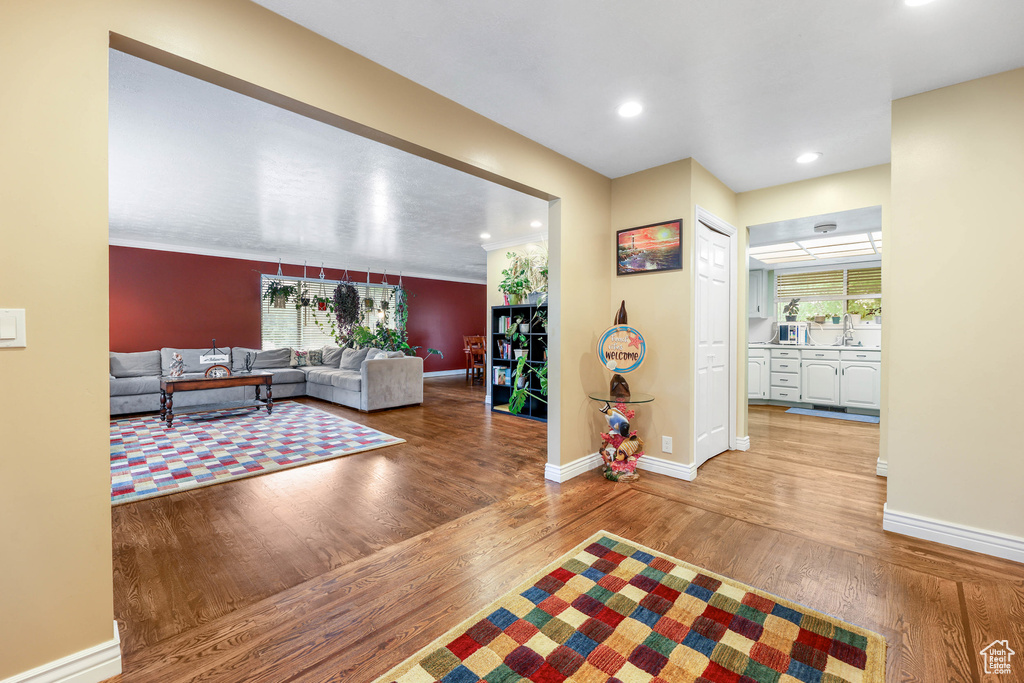 Living room featuring baseboards, recessed lighting, and wood finished floors