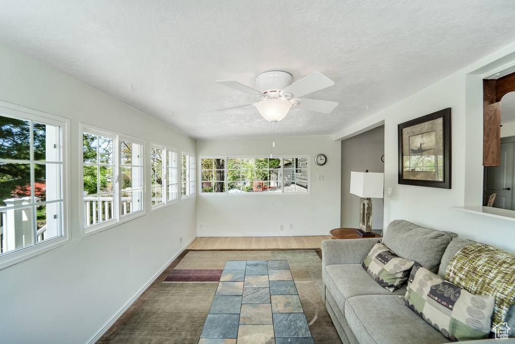 Sunroom with a healthy amount of sunlight, baseboards, and a textured ceiling