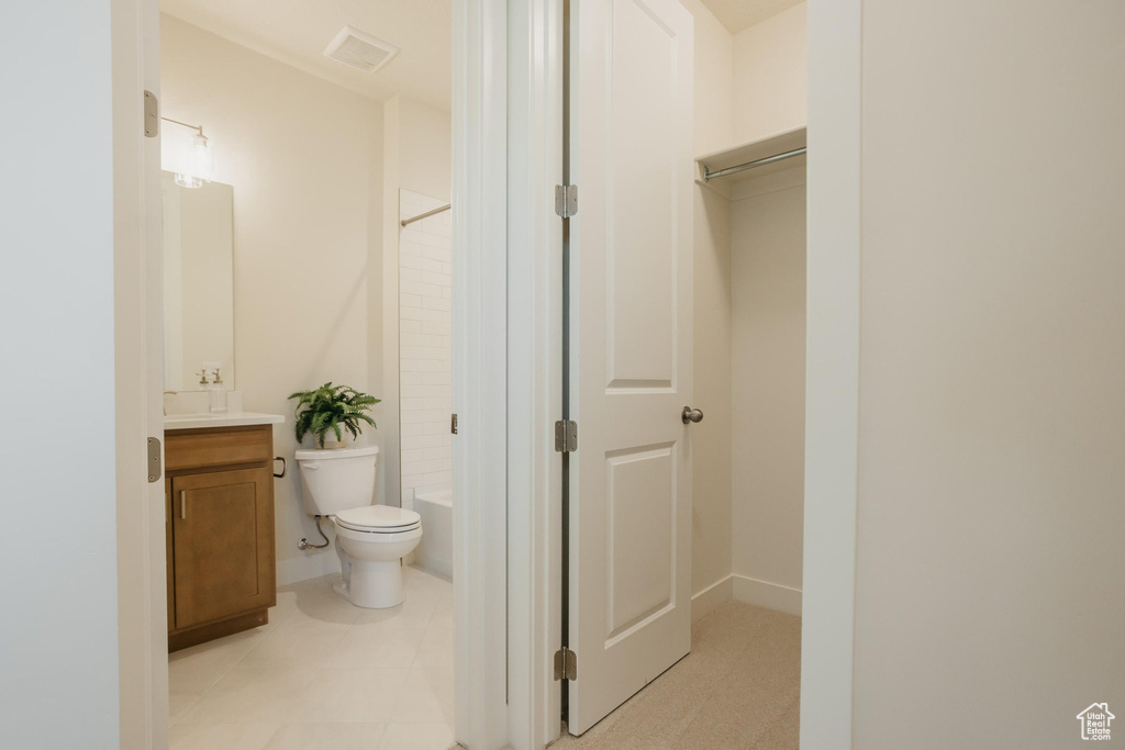 Bathroom with vanity, tub / shower combination, visible vents, and toilet